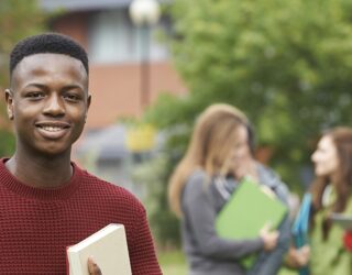 Students on campus with books, engaging in academic activities