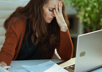 woman looking stressed on computer