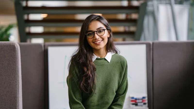 Young woman standing in front of a desk