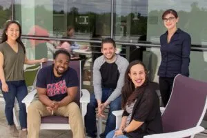 A group of GreenPath employees facing the camera smiling.