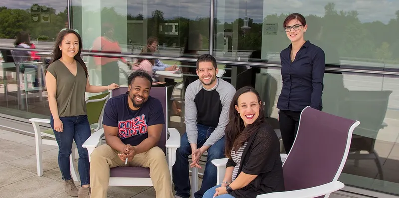 A group of GreenPath employees facing the camera smiling.