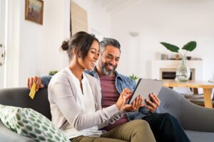 couple looking at tablet on the couch