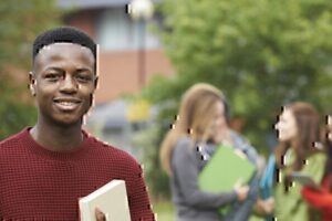 Students on campus with books, engaging in academic activities