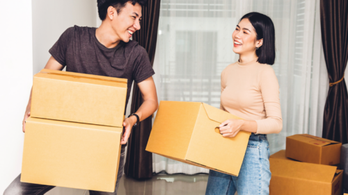 Young couple with boxes, moving into first home