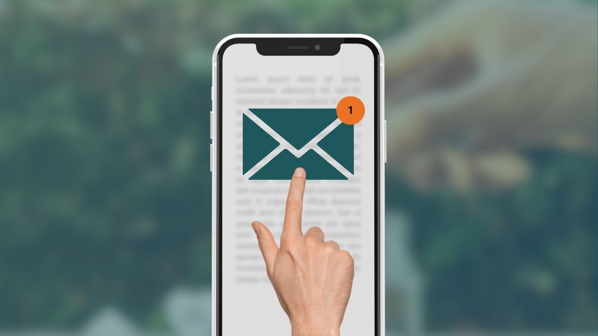 A hand clicking on an email icon on a mobile phone.