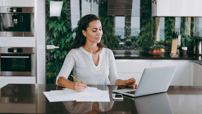 Woman in white blouse working on a computer.