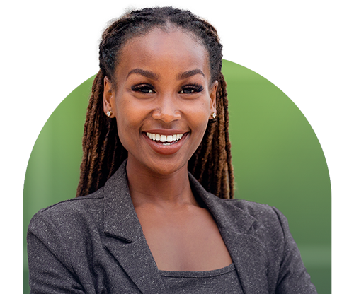 A young woman, in a business suit, smiling in front of a green backdrop