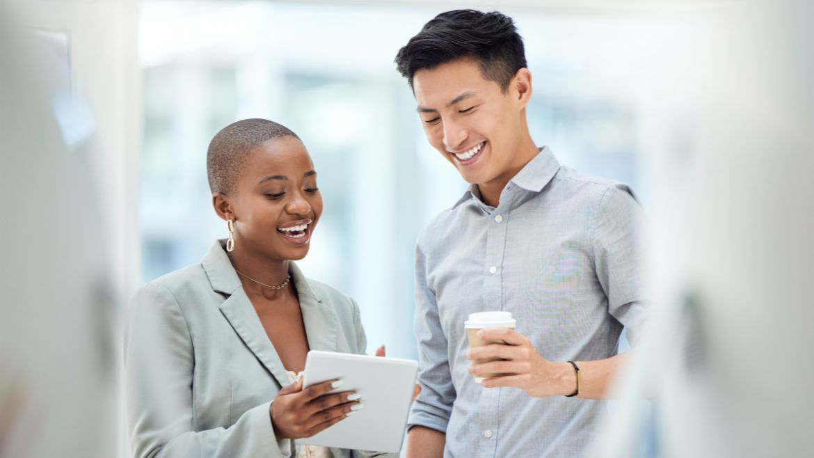 Two colleagues looking at a tablet. 